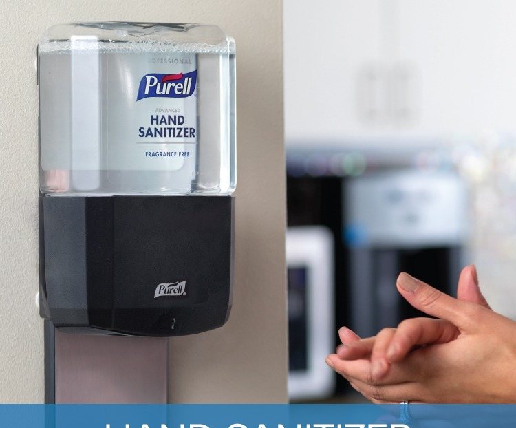 PURELL ES8 touch-free hand sanitizer dispenser on a wall in an office