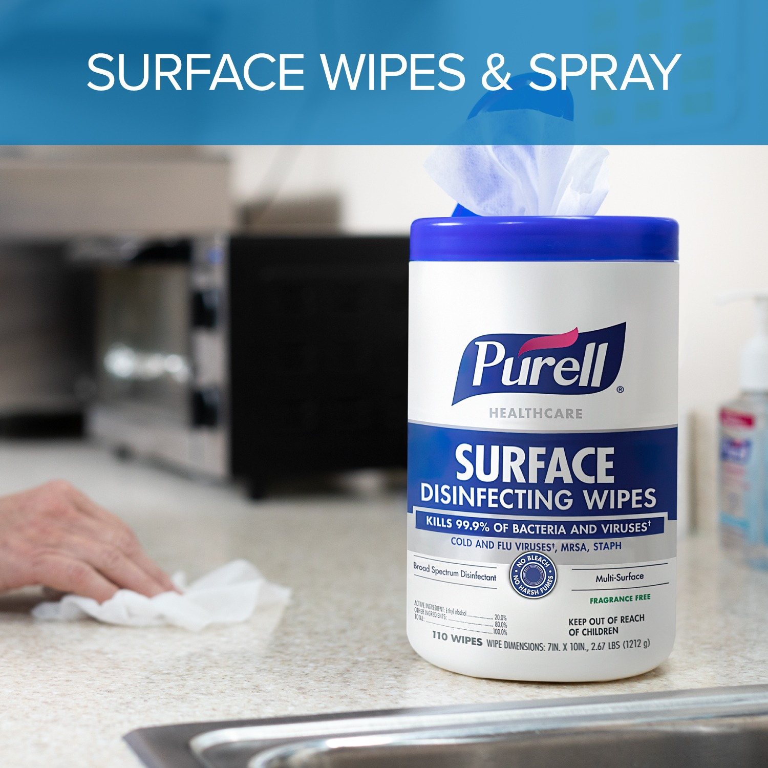 Hand pulling a PURELL surface disinfecting wipe from a canister on a kitchen counter