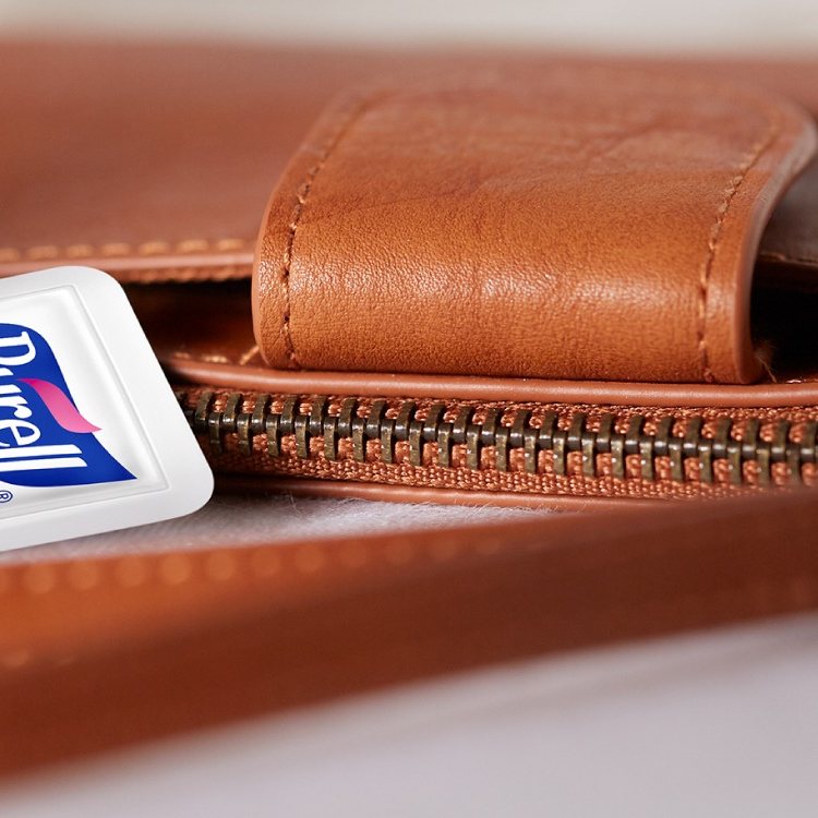 PURELL travel size hand sanitizer tucked into a leather wallet